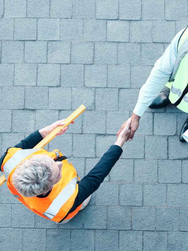 builder-construction-worker-and-architect-handsha-2025-04-06-10-51-13-utc Builder, construction worker and architect handshake with aerial view of teamwork, labor collaborat.